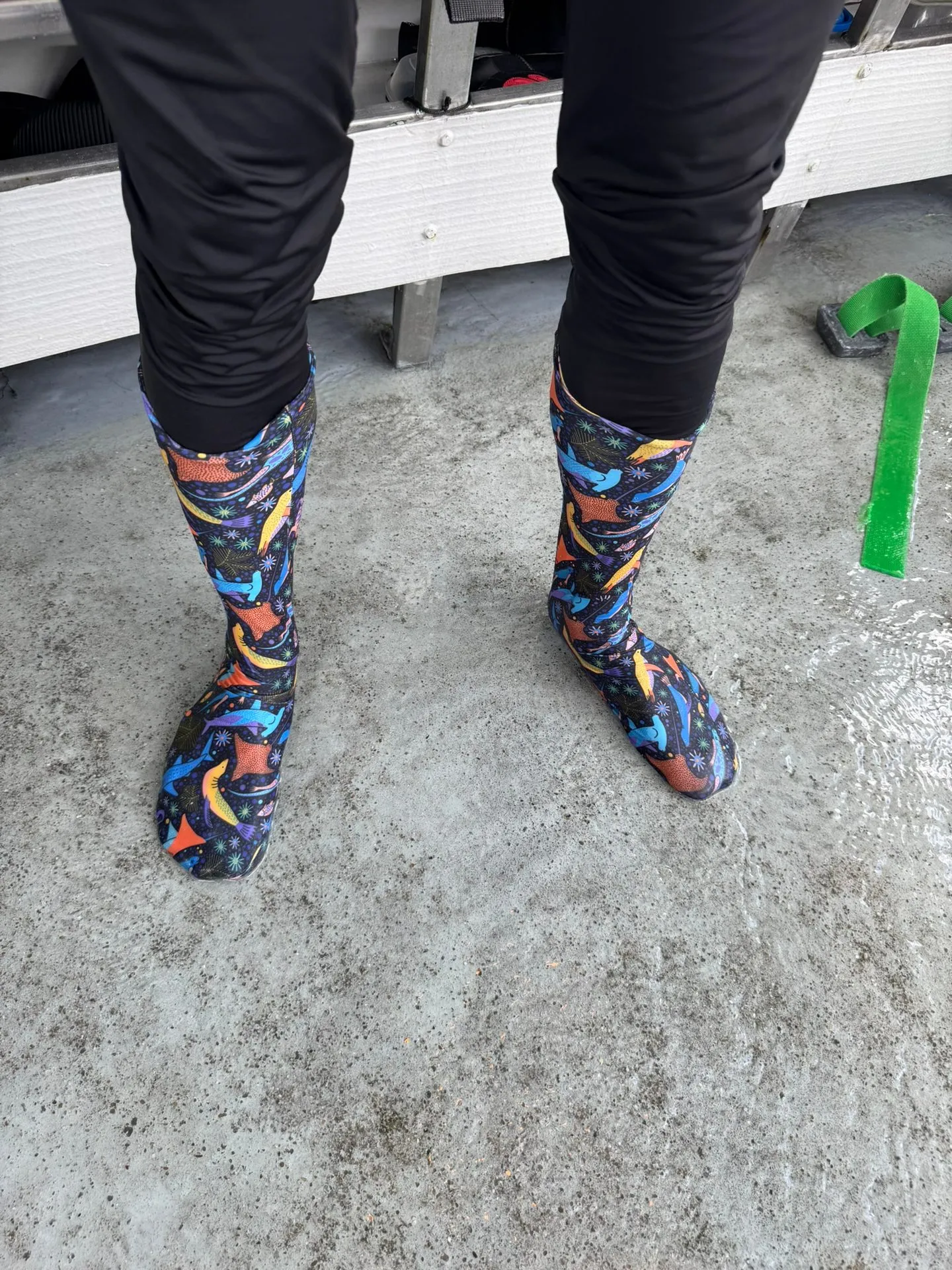 Prototype dive socks worn on the wet deck of a dive boat