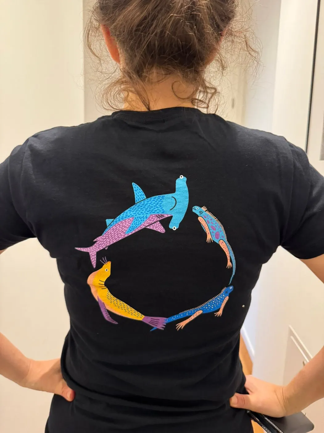 The finished marine print worn on apparel, hammerheads circling on the back