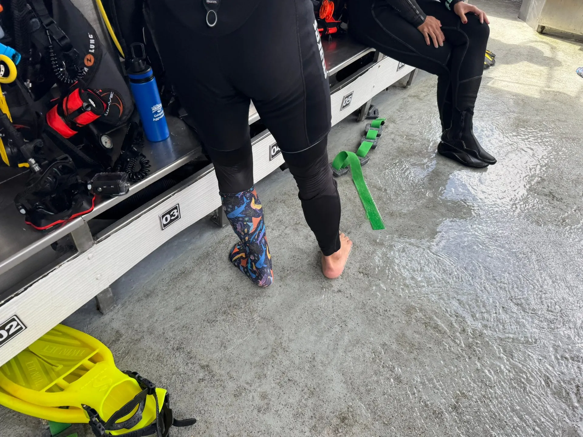Prototype dive sock worn on a wet dive boat deck