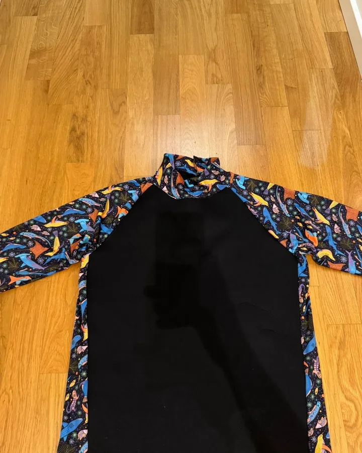 A hand-sewn soggylife rashguard prototype, solid body with printed raglan sleeves