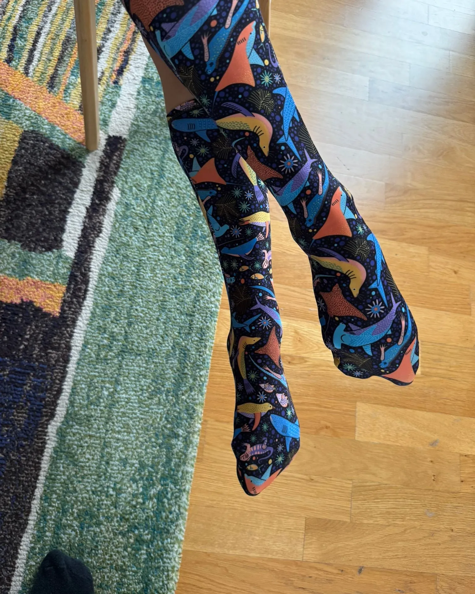 Legs wearing finished soggylife dive socks in a colourful marine print