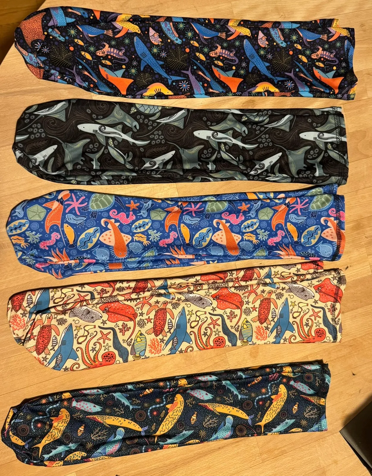 Three hand-sewn dive sock prototypes in different marine prints
